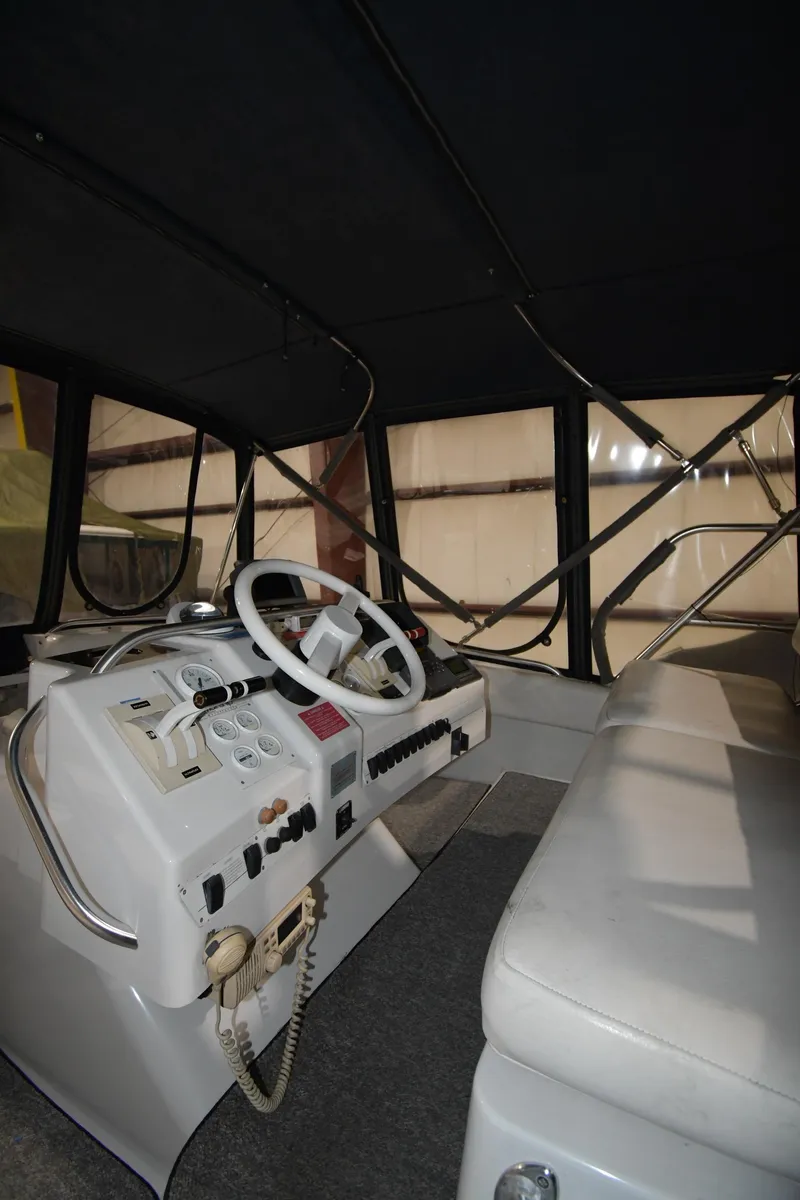 Slide: The Image of 1997 Mainship 40 Sedan Bridge interior helm with steering wheel and controls. - 14