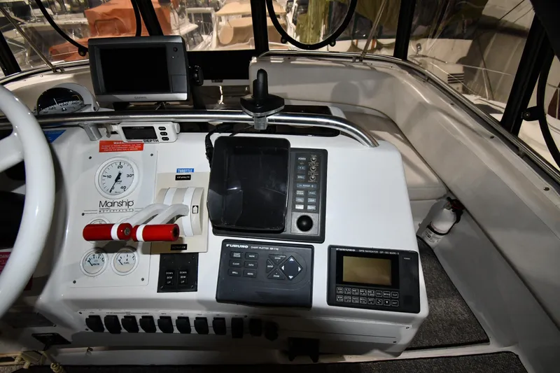 Slide: The Image of 1997 Mainship 40 Sedan Bridge helm with navigation instruments and controls. - 17