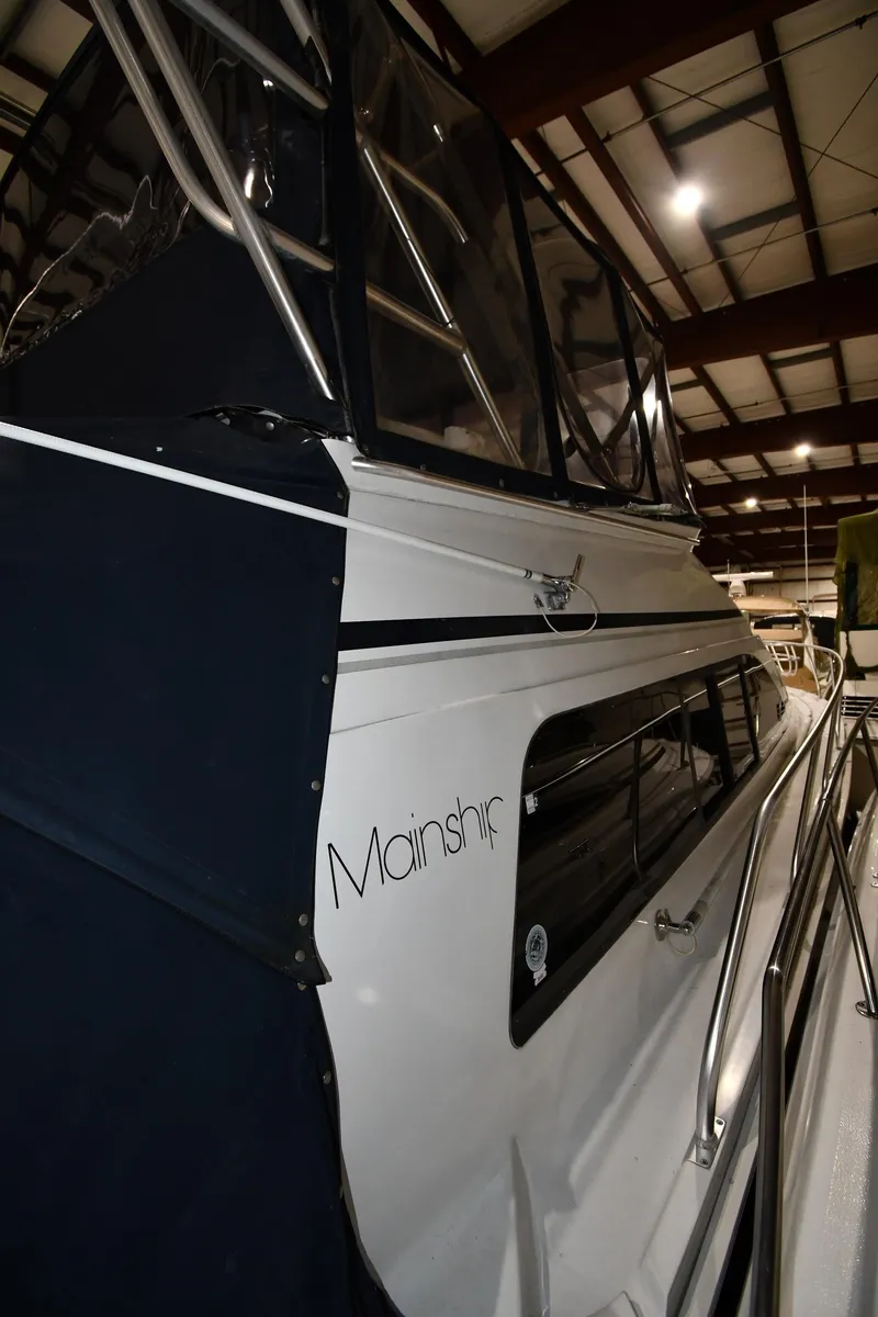 Slide: The Image of 1997 Mainship 40 Sedan Bridge yacht in indoor storage facility. - 2