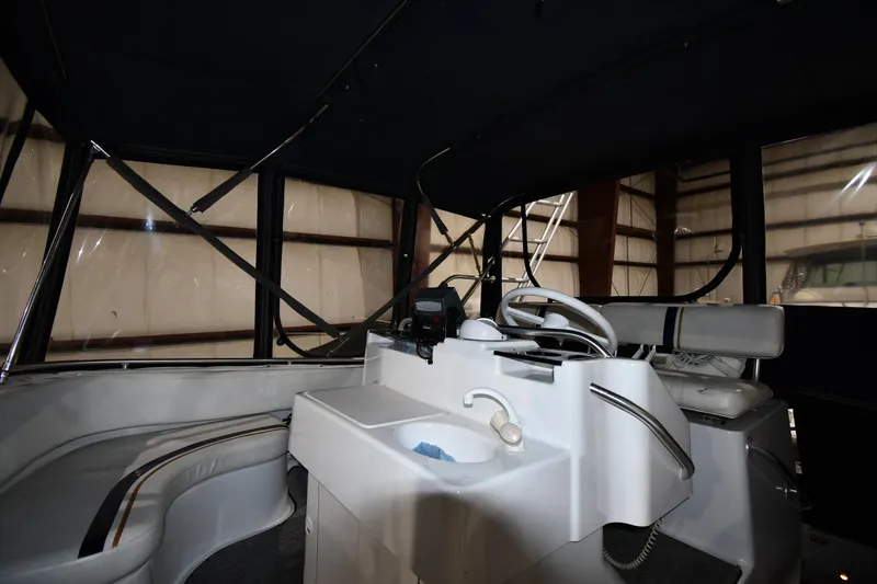 Slide: The Image of 1997 Mainship 40 Sedan Bridge interior with helm, seating, and sink. - 20