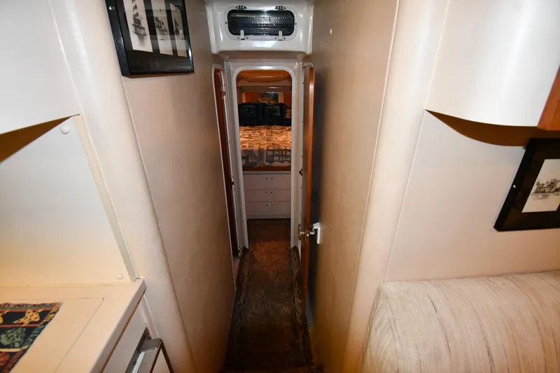 Slide: The Image of Narrow hallway inside a 1997 Mainship 40 Sedan Bridge yacht, leading to a cabin. - 21