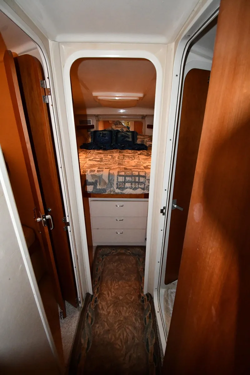 Slide: The Image of 1997 Mainship 40 Sedan Bridge interior cabin with bed and storage drawers. - 22