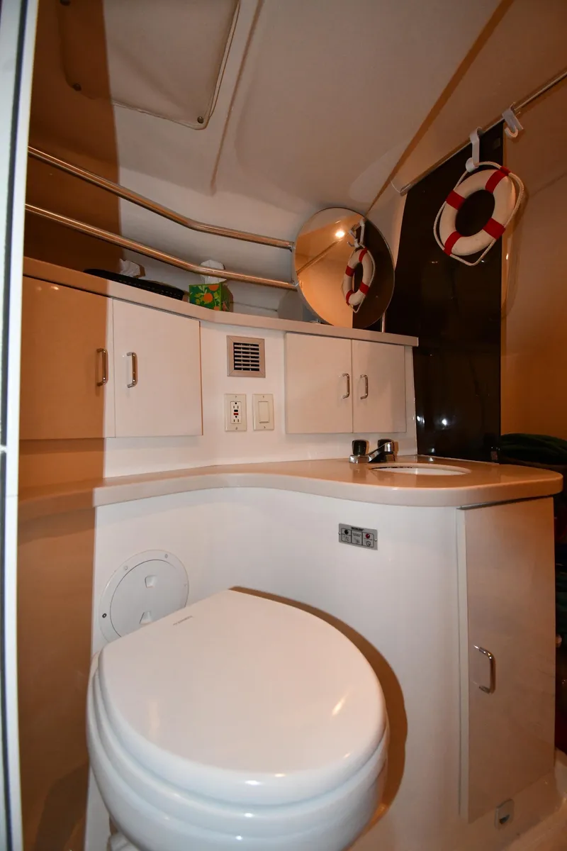 Slide: The Image of 1997 Mainship 40 Sedan Bridge bathroom with toilet, sink, and storage cabinets. - 30