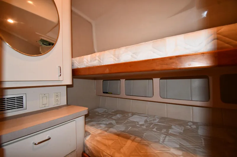 Slide: The Image of 1997 Mainship 40 Sedan Bridge cabin with bunk beds and storage. - 33