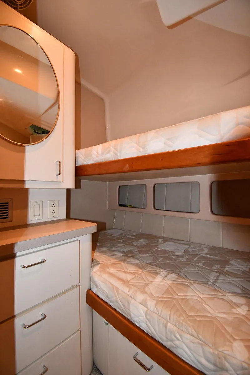 Slide: The Image of 1997 Mainship 40 Sedan Bridge cabin with bunk beds and storage drawers. - 34