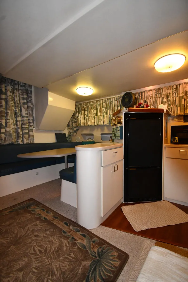 Slide: The Image of Interior of 1997 Mainship 40 Sedan Bridge with dining area and kitchenette. - 36