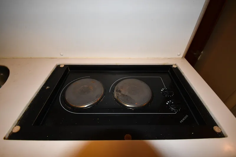 Slide: The Image of Built-in stovetop on 1997 Mainship 40 Sedan Bridge yacht. - 45