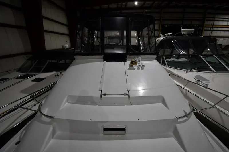 Slide: The Image of 1997 Mainship 40 Sedan Bridge yacht in storage, showcasing sleek design and spacious deck. - 6