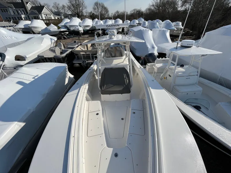 Slide: The Image of 2018 Regulator 31 boat in marina, surrounded by covered vessels. - 11