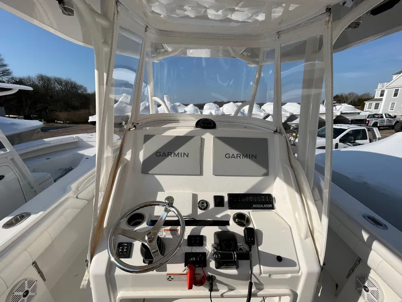 Slide: The Image of 2018 Regulator 31 boat console with Garmin displays and steering wheel. - 12