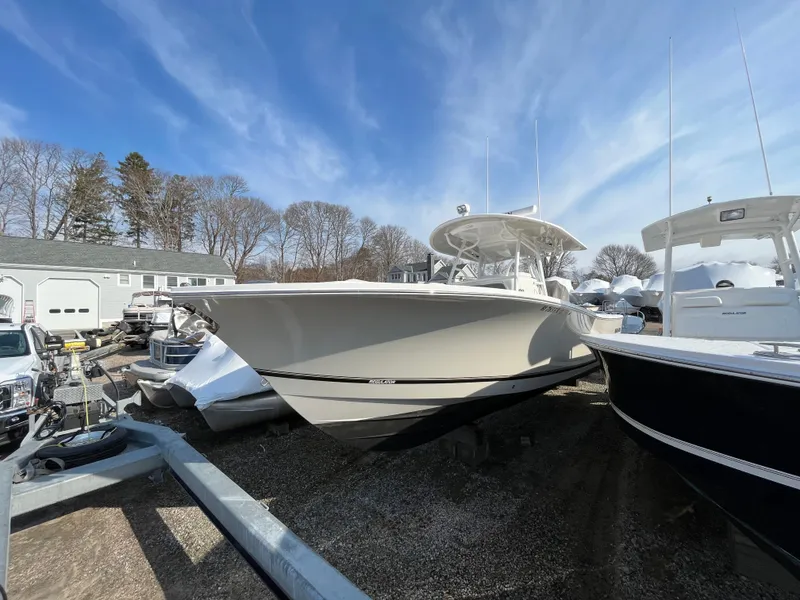 Slide: The Image of 2018 Regulator 31 boat on display in a marina under a clear blue sky. - 2