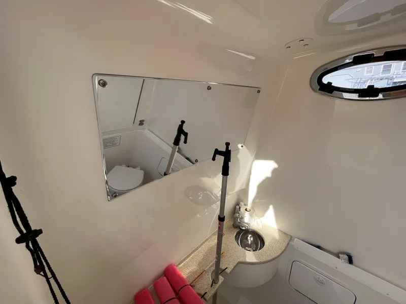 Slide: The Image of Interior of 2018 Regulator 31 boat bathroom with mirror and sink. - 22