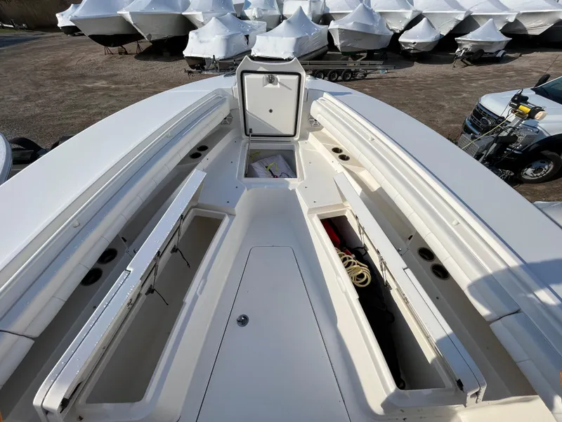 Slide: The Image of 2018 Regulator 31 boat deck with open storage compartments and visible ropes. - 25