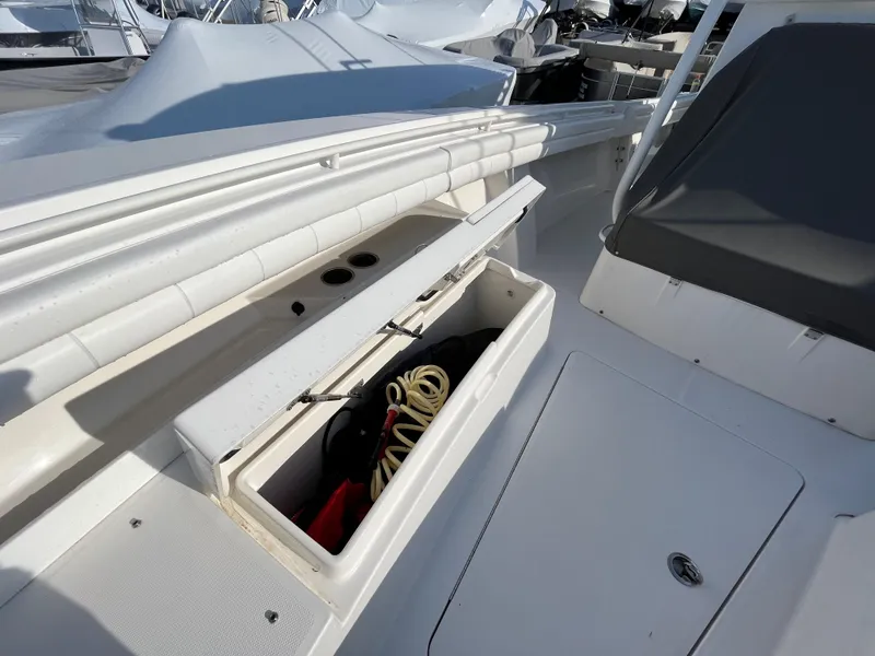 Slide: The Image of 2018 Regulator 31 boat with open storage compartment and seating area. - 26