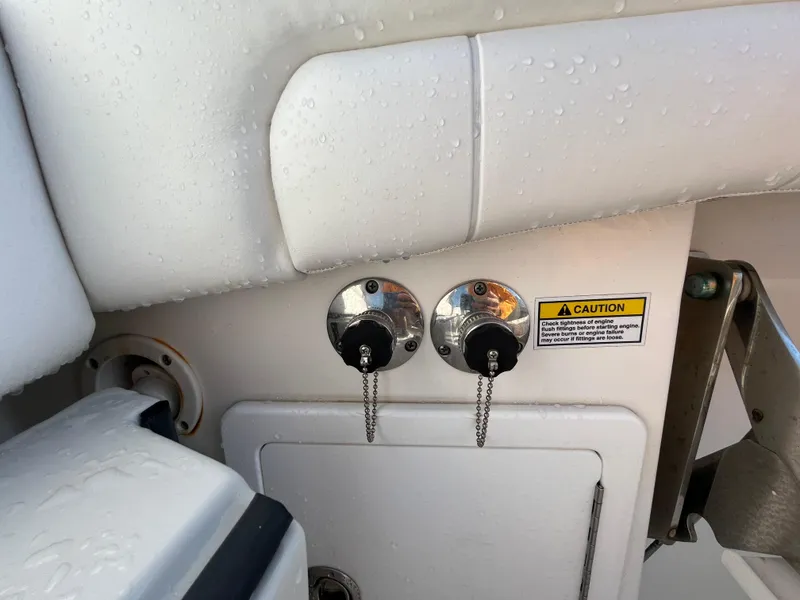 Slide: The Image of 2018 Regulator 31 boat fuel caps with caution label, wet surface. - 30