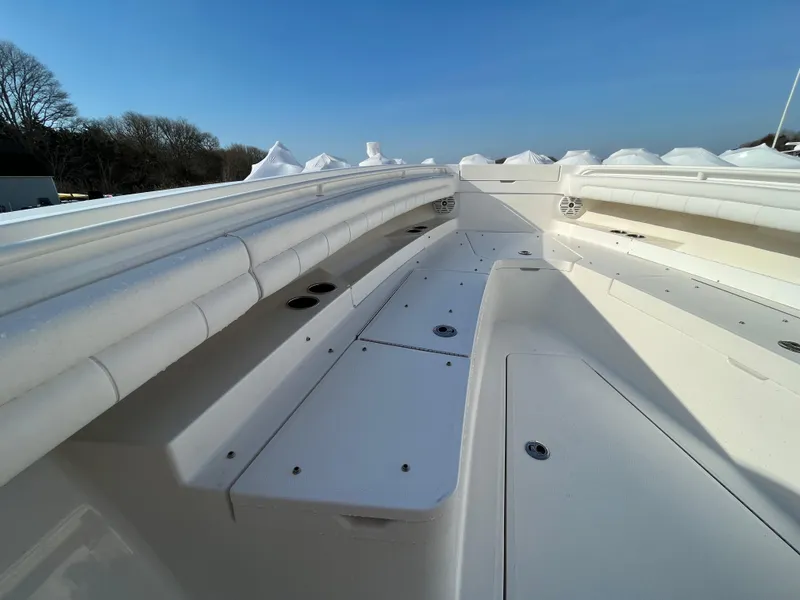 Slide: The Image of 2018 Regulator 31 boat deck with white seating and storage compartments. - 32