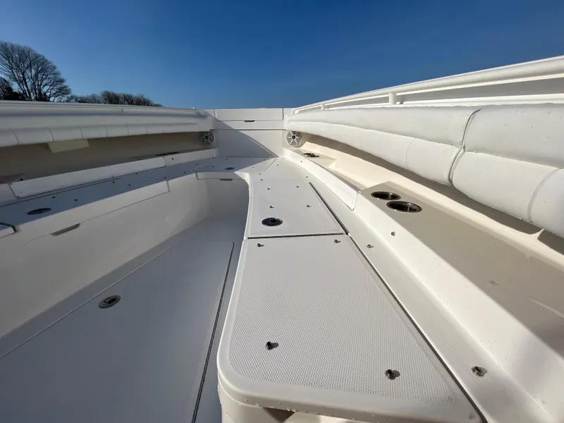 Slide: The Image of 2018 Regulator 31 boat interior with white seating and storage compartments. - 33