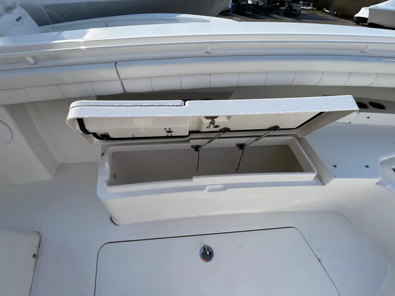 Slide: The Image of 2018 Regulator 31 boat with open storage compartment on deck. - 34