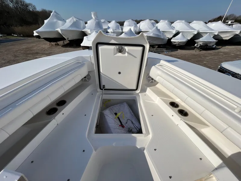 Slide: The Image of 2018 Regulator 31 boat with open storage compartment, surrounded by covered boats. - 35