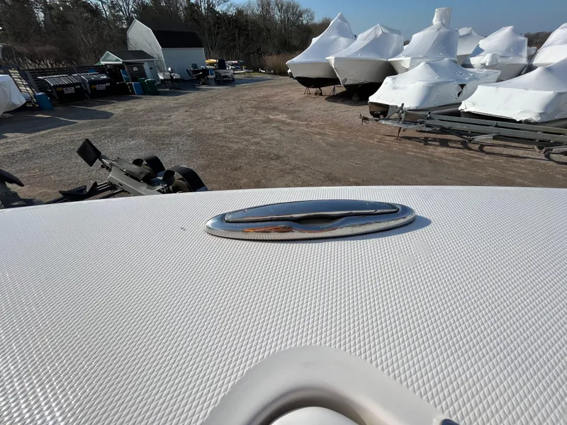Slide: The Image of 2018 Regulator 31 boat in storage yard with covered boats in background. - 38