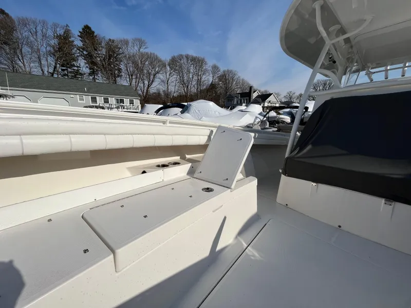 Slide: The Image of 2018 Regulator 31 boat deck with seating, under clear blue sky. - 41