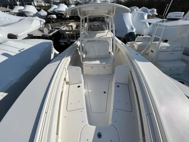 Slide: The Image of 2018 Regulator 31 boat, white interior, docked among other boats. - 43