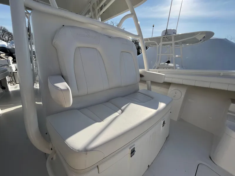 Slide: The Image of 2018 Regulator 31 boat with white cushioned seating and storage compartments. - 44