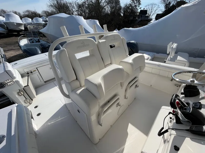 Slide: The Image of 2018 Regulator 31 boat interior with white seating and steering console. - 47