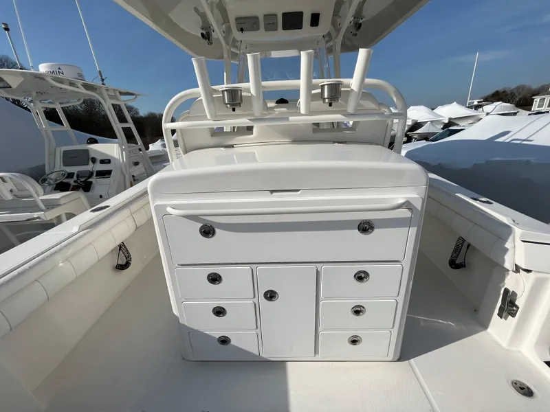 Slide: The Image of 2018 Regulator 31 boat interior with storage compartments and rod holders. - 48