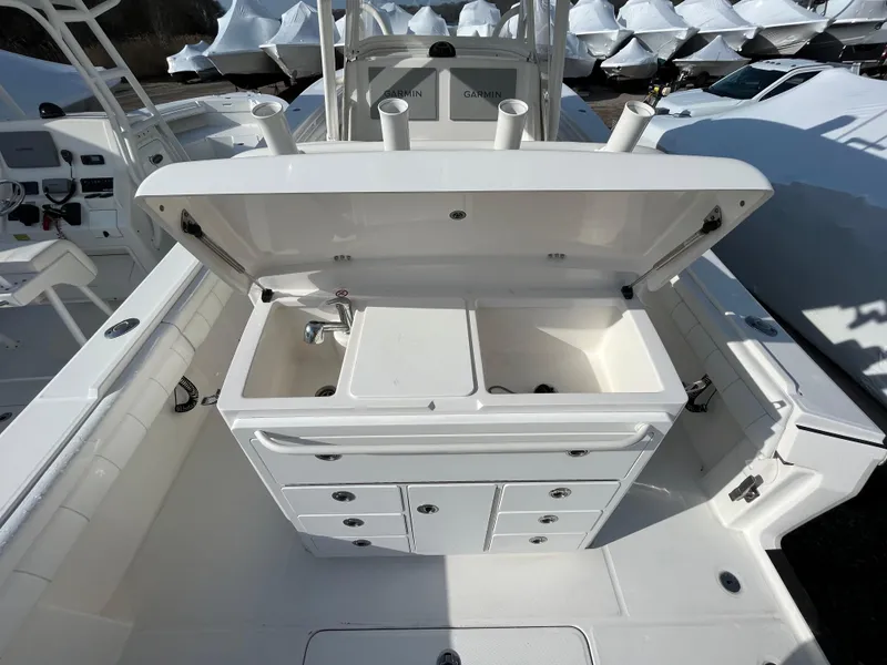 Slide: The Image of 2018 Regulator 31 boat with open storage compartment and sink on deck. - 49