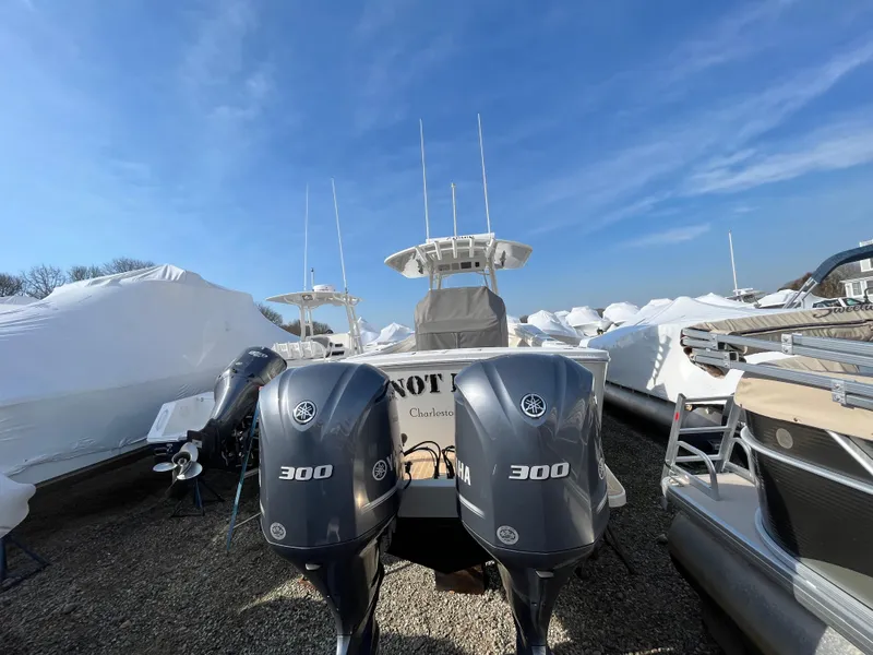 Slide: The Image of 2018 Regulator 31 boat with twin Yamaha 300 engines, stored outdoors under clear blue sky. - 6