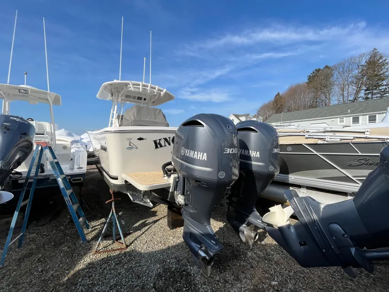Slide: The Image of 2018 Regulator 31 boat with Yamaha engines in a marina setting. - 7