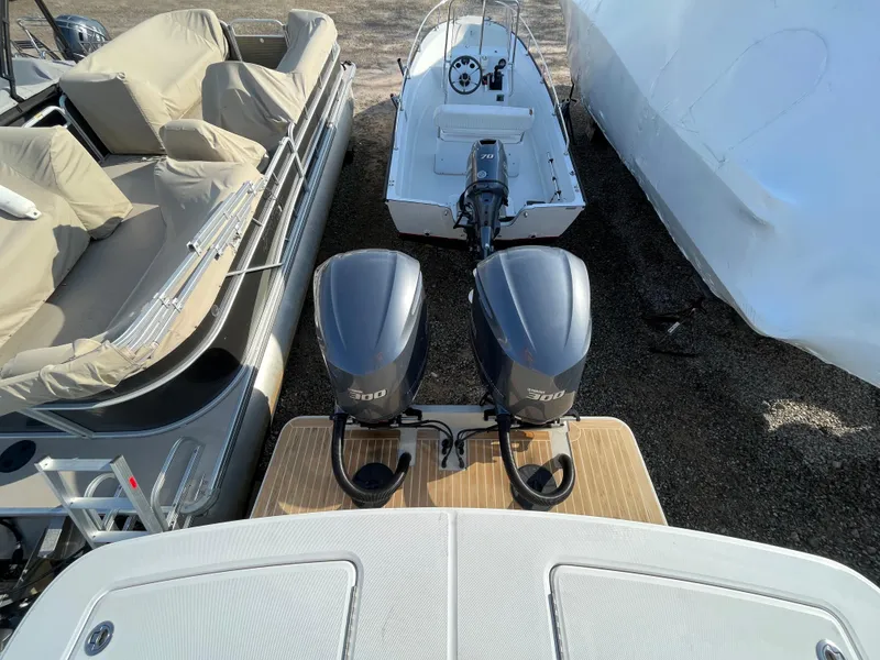Slide: The Image of 2018 Regulator 31 boat with twin 700 engines, docked alongside other boats. - 8