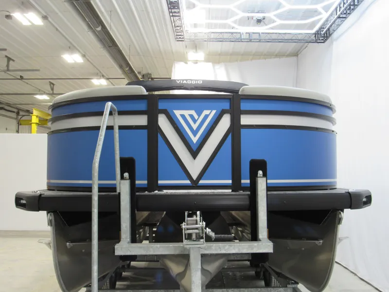 Slide: The Image of 2025 Viaggio X24U pontoon boat in a showroom, showcasing sleek design and modern features. - 1