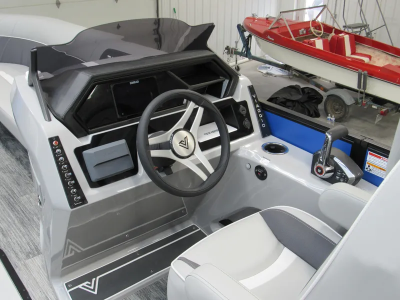Slide: The Image of Viaggio X24U 2025 boat dashboard with steering wheel and control panel in a garage setting. - 5