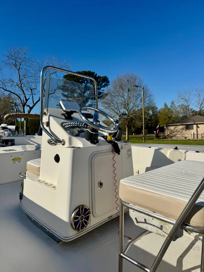 Slide: The Image of 2014 Carolina Skiff 198 DLV boat interior with steering console under clear blue sky. - 5