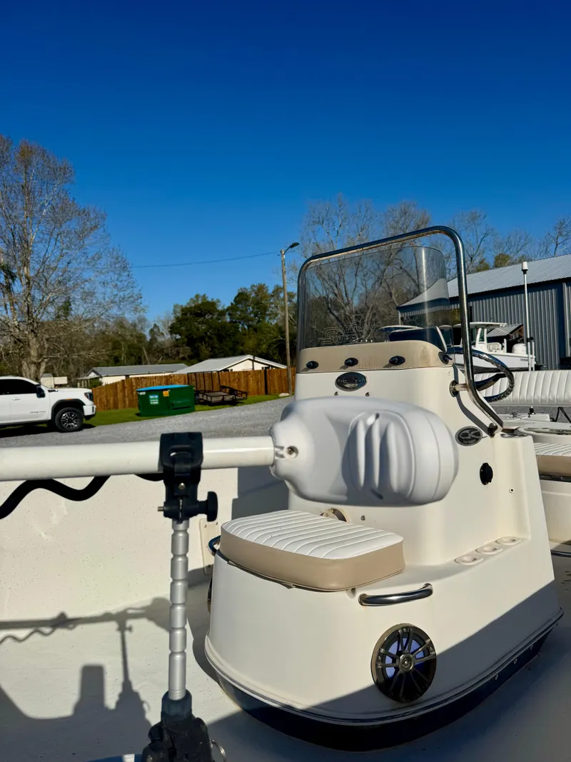 Slide: The Image of 2014 Carolina Skiff 198 DLV boat with console, under clear blue sky. - 7