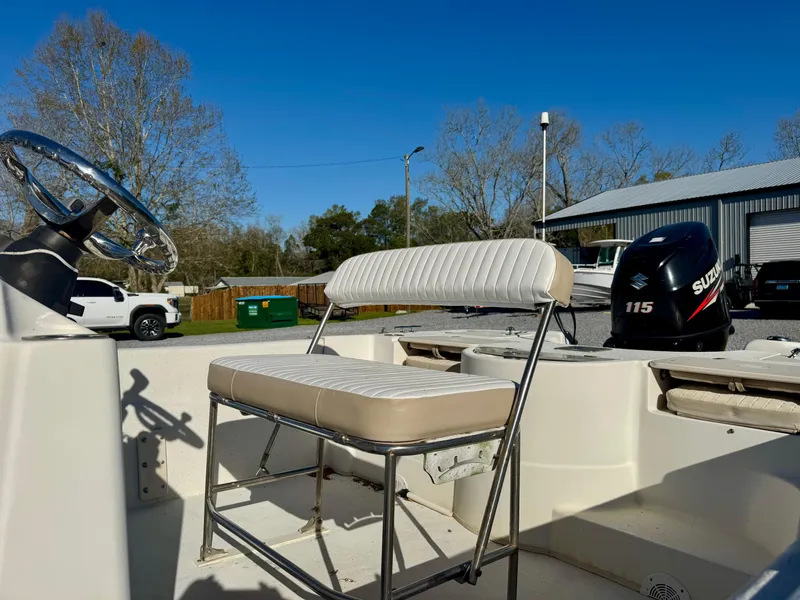 Slide: The Image of 2014 Carolina Skiff 198 DLV boat interior with seating and Suzuki 115 outboard motor. - 8