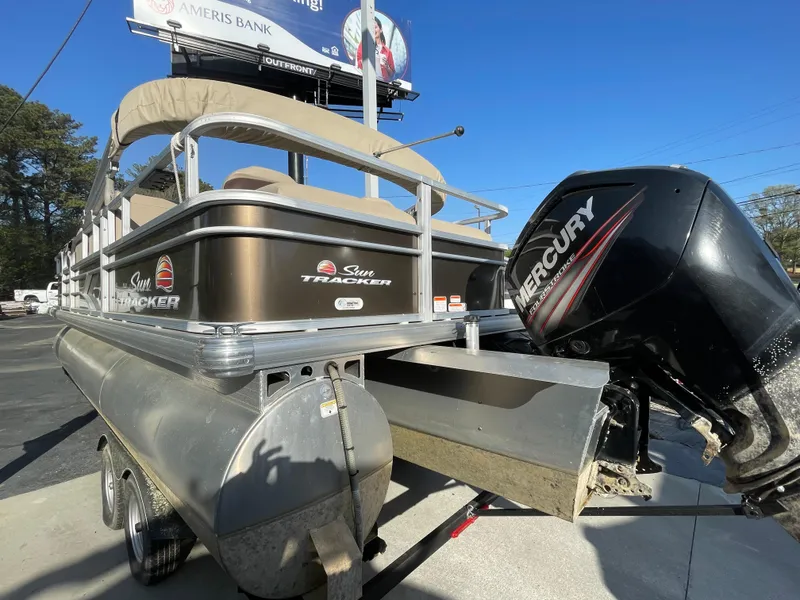 Slide: The Image of 2019 Sun Tracker SportFish 22 DLX pontoon boat with Mercury outboard motor on trailer. - 19