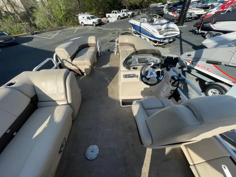 Slide: The Image of 2019 Sun Tracker SportFish 22 DLX pontoon boat interior with beige seating and steering console. - 29