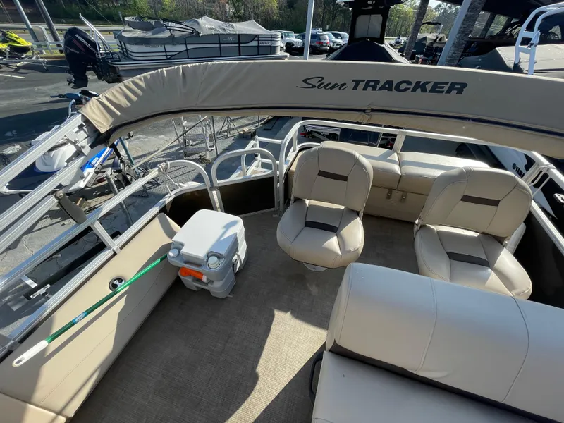 Slide: The Image of 2019 Sun Tracker SportFish 22 DLX pontoon boat interior with beige seating and canopy. - 32