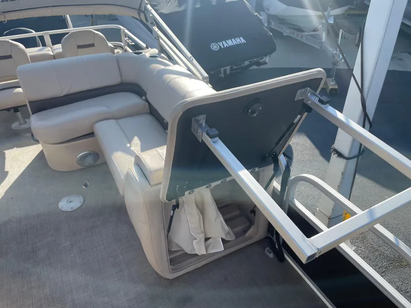 Slide: The Image of 2019 Sun Tracker SportFish 22 DLX boat interior with open storage compartment. - 33