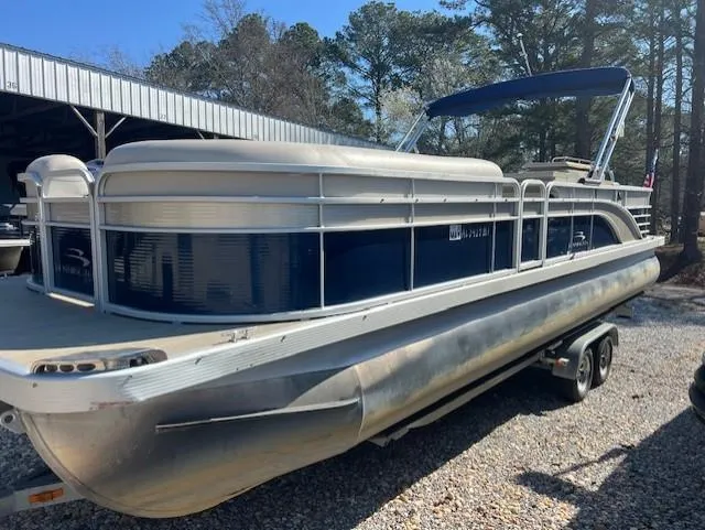 Slide: The Image of 2015 Bennington 2574 GCW pontoon boat on a trailer, parked outdoors. - 5