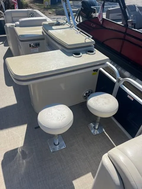 Slide: The Image of 2015 Bennington 2574 GCW boat interior with seating and table setup. - 8