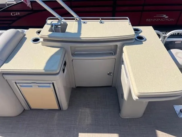 Slide: The Image of 2015 Bennington 2574 GCW boat interior with kitchenette and storage compartments. - 9