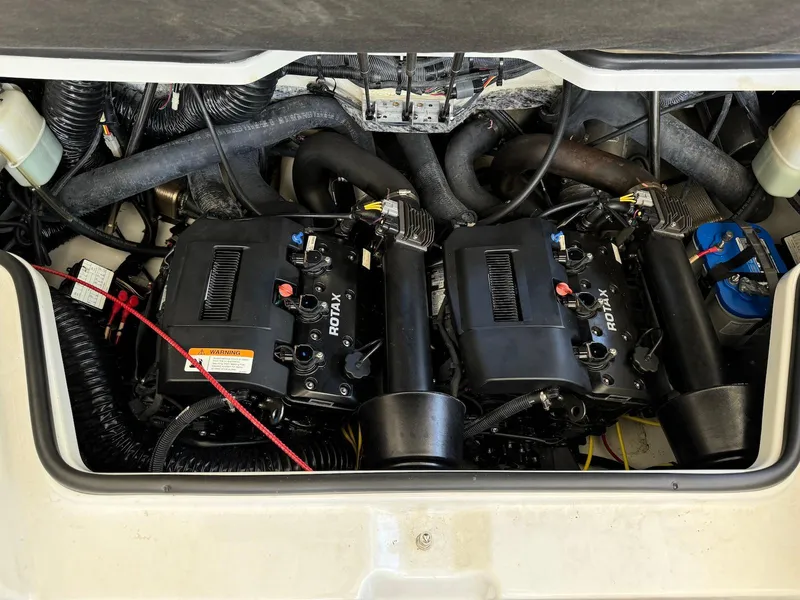 Slide: The Image of Engine compartment of a 2021 Scarab 215 ID boat featuring dual Rotax engines. - 14