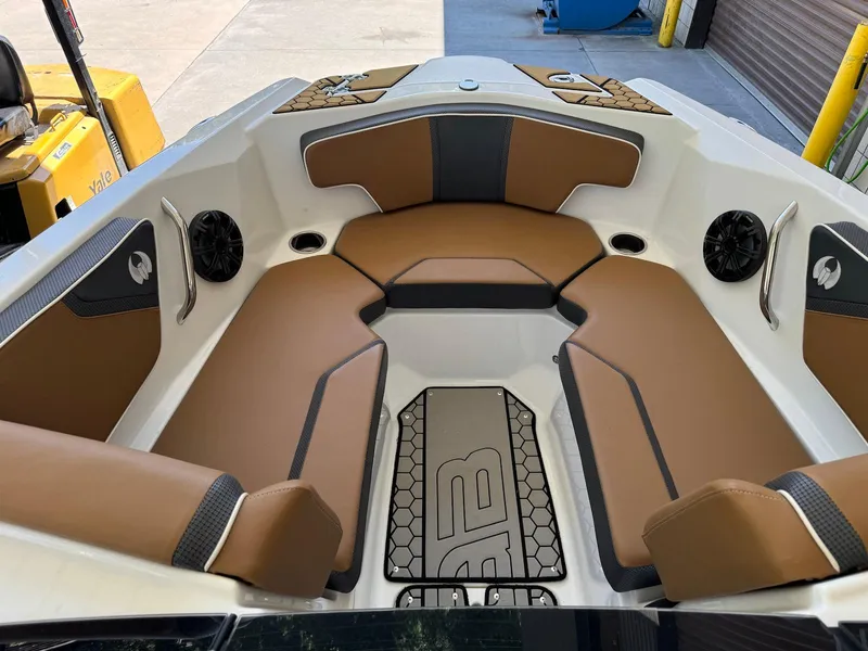 Slide: The Image of 2021 Scarab 215 ID boat interior with brown seating and modern design. - 15