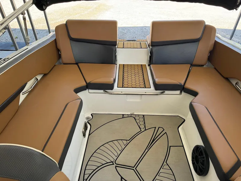 Slide: The Image of 2021 Scarab 215 ID boat interior with tan and gray seating, stylish flooring, and modern design. - 16