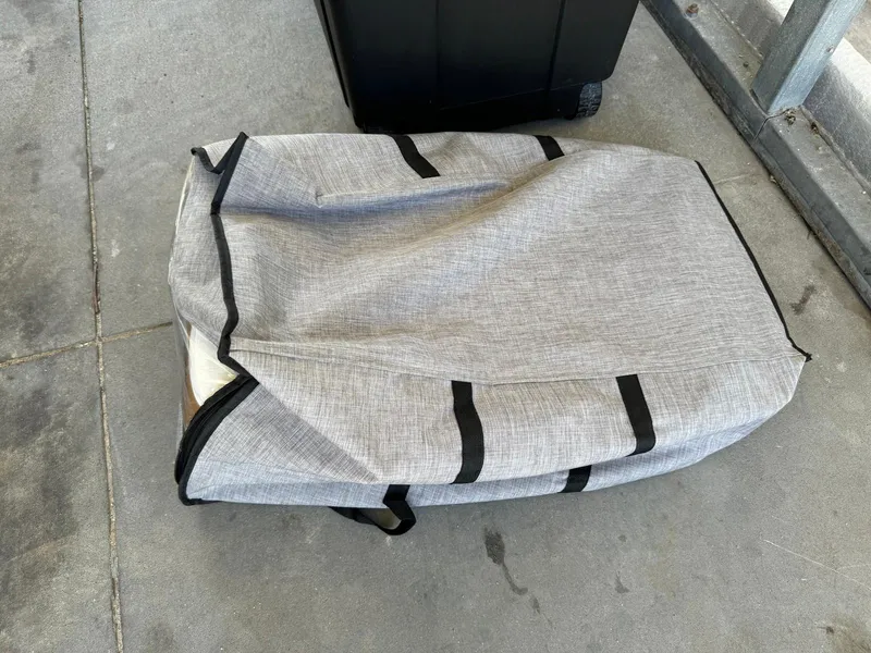 Slide: The Image of Gray fabric bag on concrete floor, near a black suitcase. - 19