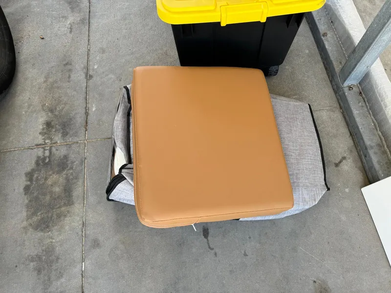 Slide: The Image of Cushion from 2021 Scarab 215 ID boat on concrete floor near storage box. - 20